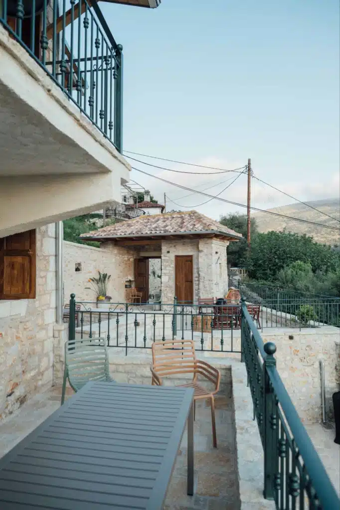 Balcony view over the stone rooftops of Foiniki and the surrounding mountains, Valaes Guesthouse