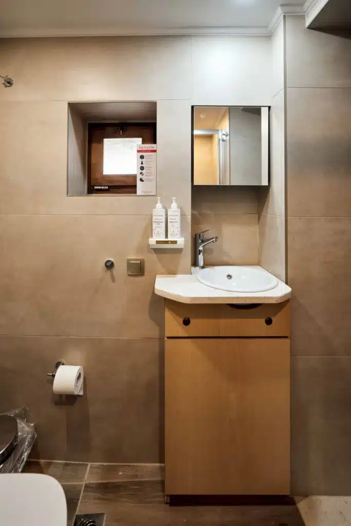 Bathroom vanity with mirror and washbasin, Valaes Guesthouse, Foiniki