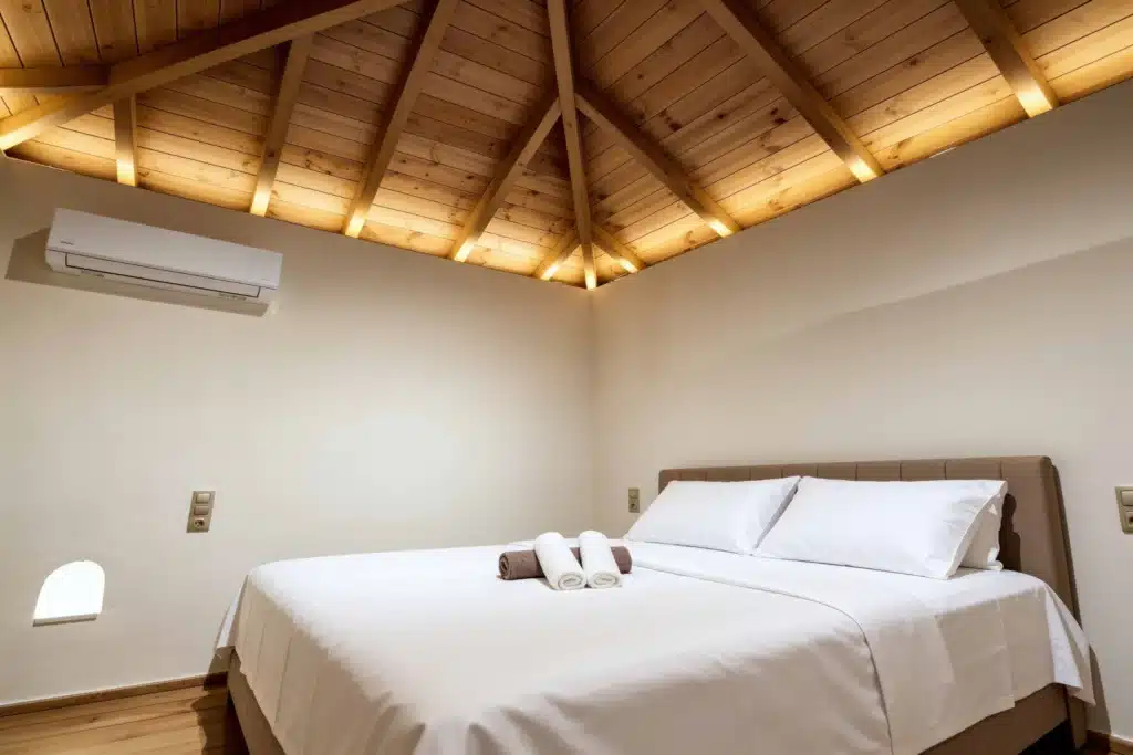 Bedroom with a double bed, timber-beamed ceiling and A/C, Valaes Guesthouse, Foiniki