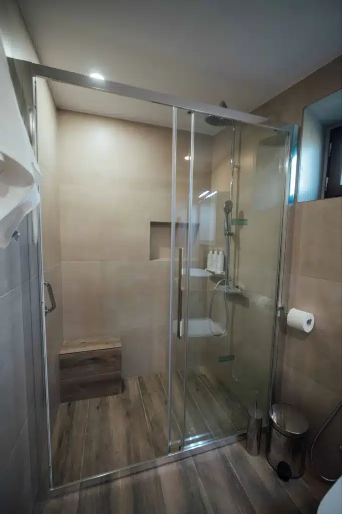 Glass shower and stone-wall bathroom, Valaes Guesthouse, Foiniki