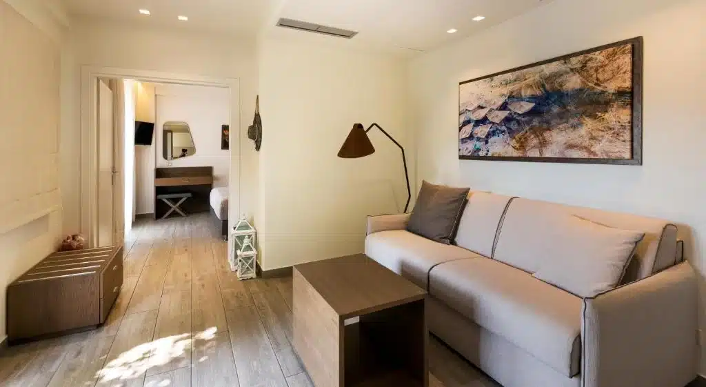 Living area with sofa and sea-inspired artwork in a Prima Vista suite