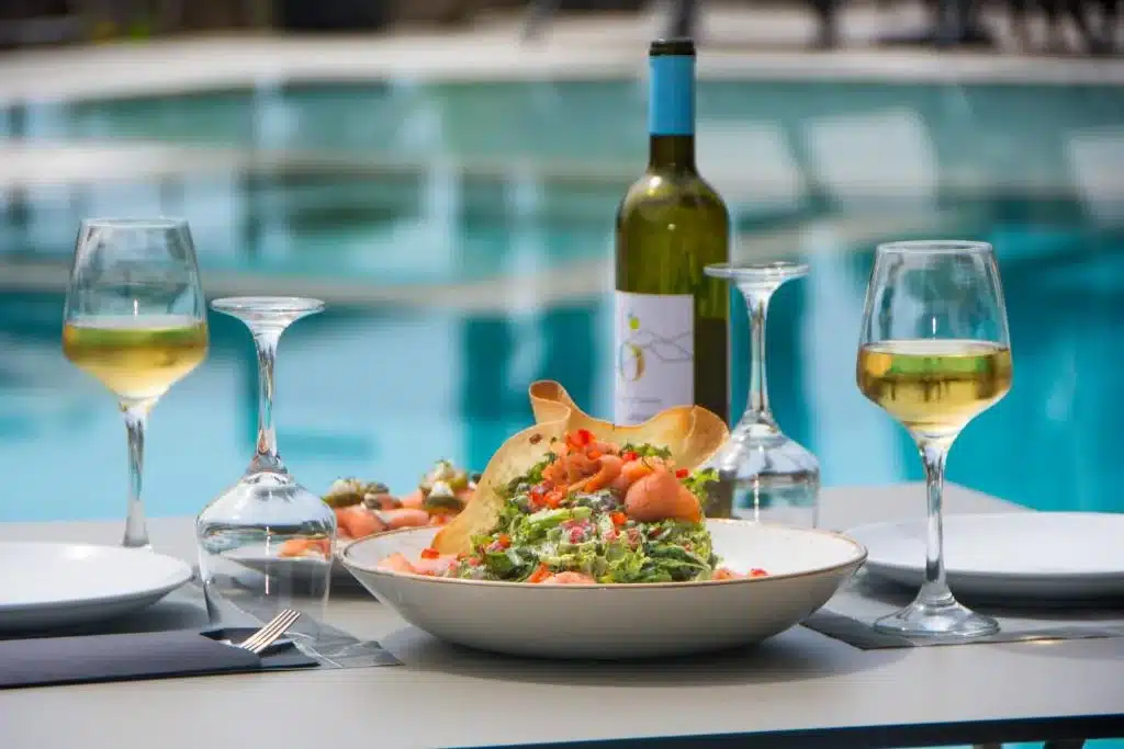 Lunch with white wine by the pool at Prima Vista