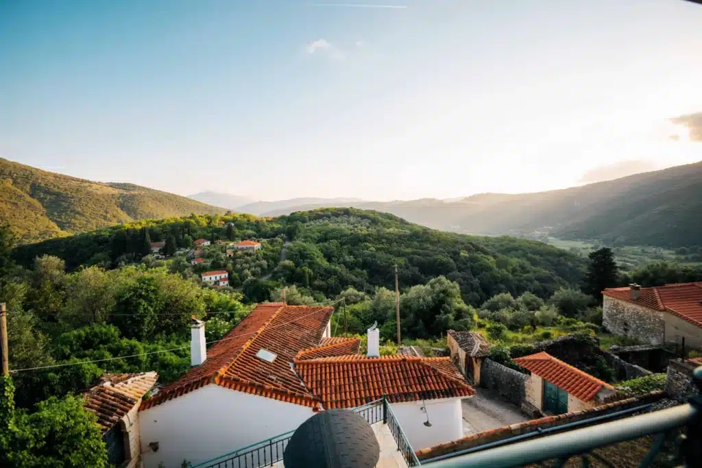 View over the tiled rooftops of Foiniki toward the green hills, Thesprotia