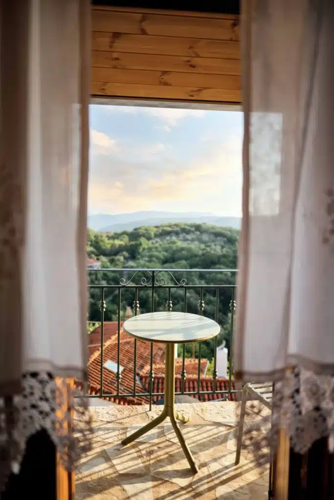 Window view from a suite over the valley, with a table and chairs on the balcony, Valaes Guesthouse, Foiniki