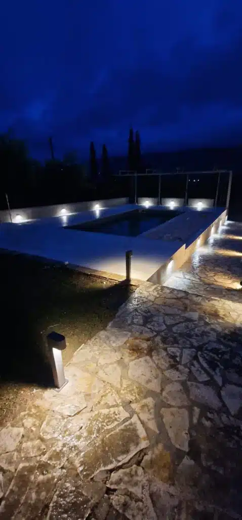 Pool and terrace lit in the evening at Casa di campagna